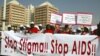 People holding banners march to campaign for increased aids awareness in the streets of Nigeria's capital Abuja December 1, 2006 on World Aids Day.