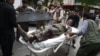 A wounded Afghan man is brought on a stretcher to an Italian aid organization's hospital, as Afghan security forces battled an ongoing attack by Taliban militants on a compound housing an international aid organisation in Kabul on May 8, 2019.