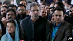 Shahid Khaqan Abbasi, center, speaks to reporters following a supreme court decision in Islamabad, Pakistan, March 26, 2019.