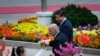 Afghanistan's President Ashraf Ghani Ahmadzai (L) waves to students as he and China's President Xi Jinping attend a welcoming ceremony outside the Great Hall of the People, in Beijing, Oct. 28, 2014.