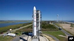 This image provided by NASA shows the Lunar Atmosphere and Dust Environment Explorer aboard a Minotaur V rocket after a rollout at NASA's Wallops Island test flight facility in Wallops Island, Va., Sept. 5, 2013.