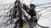 FILE - An official of Nigeria Power works on power lines in Lagos, Nigeria, July 22, 2011. 