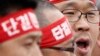 FILE - Han Sang-gyun (R) speaks at a protest in Pyeongtaek, about 70 km (43 miles) south of Seoul.