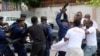 FILE - Congolese police officers attempt to disperse members of the Civil Society Action Collective (CASC) chanting slogans as they protest to demand free fair elections in Kinshasa, Democratic Republic of Congo, Sept. 19, 2018.