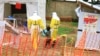 Photo taken Sept 9, 2018, shows health workers walking with a boy suspected of having the Ebola virus at an Ebola treatment centre in Beni, Eastern Congo.