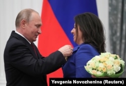 RUSSIA -- Russian President Vladimir Putin decorates editor-in-chief of Russian broadcaster RT Margarita Simonyan with the Order of Aleksandr Nevsky during an awarding ceremony at the Kremlin in Moscow, May 23, 2019