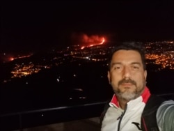 Carlos Gutiérrez, venezolano en La Palma, muestra a sus espaldas un caudal de lava volcánica. [Foto: Cortesía del Carlos Gutiérrez]