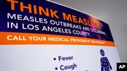 ARCHIVO - Un cartel publicado por el Departamento de Salud Pública del Condado de Los Ángeles muestra información sobre la respuesta al sarampión y las órdenes de cuarentena en Los Ángeles, el 26 de abril de 2019