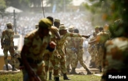 FILE - Security personnel take action against protesters in Bishoftu town in Ethiopia's Oromia region, Oct. 2, 2016. Critics say that ahead of elections or during moments of sustained protests the Ethiopian government has been known to resort to a self-serving interpretation of the country's anti-terrorism laws to stifle dissent, selectively targeting activists and journalists.