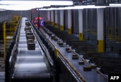 Orders move down a conveyor belt at the 855,000-square-foot Amazon fulfillment center in Staten Island, one of the five boroughs of New York City, Feb. 5, 2019.