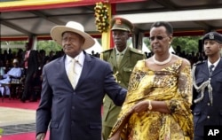 FILE - Uganda's longtime president Yoweri Museveni, left, and his wife Janet Museveniattend his last inauguration ceremony in the capital Kampala, May 12, 2016.