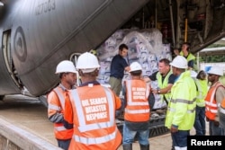 FILE - New Zealand Defense Force personnel unload aid supplies from a C-130 Hercules as part of emergency relief efforts after numerous earthquakes in the highlands region of Papua New Guinea, March 9, 2018.