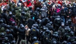 Law enforcement officers detain opposition supporters during a rally to protest against the Belarus presidential election results in Minsk, Belarus, on November 15, 2020.