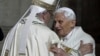 FILE - Pope Emeritus Benedict XVI, right, hugs Pope Francis in St. Peter's Basilica during a ceremony at the Vatican, Dec. 8, 2015. Benedict resigned from the papacy due to poor health in 2013; questions are being raised in 2025 as Francis remains hospitalized for a fourth week.