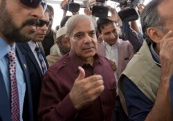 Pakistani opposition leader Shahbaz Sharif, center, arrives at the National Assembly in Islamabad, Pakistan, Aug. 17, 2018.