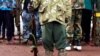 FILE - A former child soldier holds a gun during a release ceremony for child soldiers outside Yambio, South Sudan, Aug. 7, 2018.