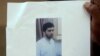  Indian man holds a copy of handout pictures released by the police showing Indian Mujahideen operative and alleged mastermind of the July 2011 Mumbai serial blasts, Yasin Bhatkal, at a press conference in Mumbai.
