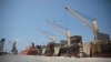 FILE - Cargo ship and oil tanker ship are idle at the port of Hodeida, Yemen, Sept. 29, 2018.