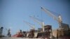 FILE - Cargo ship and oil tanker ship are idle at the port of Hodeida, Yemen, Sept. 29, 2018.