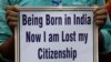 An activist holds a placard during a rally in solidarity with those affected by the final draft of the National Register of Citizens (NRC) in the northeastern state of Assam, in Kolkata, India, Aug. 1, 2018. 