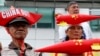 Protesters, wearing boat-shaped paper hats and mock missiles, join others in a rally at the Chinese Consulate to protest China's alleged continued militarization of the disputed islands in the South China Sea known as Spratlys, Feb. 10, 2018, in Makati city east of Manila, Philippines.