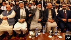 Afghan politicians, from second left to right, Mohammad Karim Khalili, Gulbuddin Hekmatyar, Haneef Atmar and Ustad Atta Mohammad Noor, and others attend the opening session of an Afghan Peace Conference in Bhurban, Pakistan, June 22, 2019.