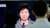 People watch a live television program showing South Korean President Park Geun-hye's speech to the nation regarding the sunken ferry Sewol at the Seoul Train Station in Seoul, South Korea, Monday, May 19, 2014.