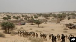 FILE - Chadian troops and Nigerian special forces participate in exercises in Mao, Chad, March 7, 2015. 