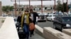 Travelers make their way to the departure lounge at Sana'a International Airport, Yemen, Aug. 6, 2013. 