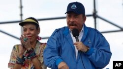 El presidente de Nicaragua, Daniel Ortega, habla a sus seguidores mientras su esposa y la vicepresidenta Rosario Murillo aplauden, en Managua, Nicaragua, el miércoles 29 de agosto de 2018.