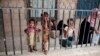 Displaced Yemeni girls and their families, who fled their homes by the fighting the port city of Hodeida, are seen in a school allocated for IDPs in Sanaa, Yemen, Saturday, Jun. 23, 2018.
