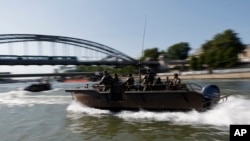 Soldados realizan un reconocimiento sobre botes en el Río Sema el miércoles 17 de julio del 2024 antes de la ceremonia de apertura de los Juegos Olímpicos de París. 