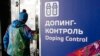 A man walks past a sign reading "Doping Control" at a 2014 Sochi Winter Olympics site in Krasnaya Polyana, Russia. Feb. 21, 2014. Moscow has been under fire for months over allegations of state-run doping. (AP Photo/Lee Jin-man)