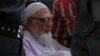 Bangladesh's Islamic party Jamaat-e-Islami former chief Ghulam Azam, center on wheelchair, is escorted by security people to a court in Dhaka, July 15, 2013. 