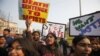 ndian students protesting against the brutal gang-rape of a woman on a bus last week in New Delhi, hold placards during a protest in Allahabad, India, Dec. 26, 2012
