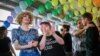Campaigners react during the first projections following a nationwide referendum on same-sex marriage, in Swiss capital Bern, Sept. 26, 2021.
