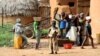 Children gather water in Bagega, Nigeria, where thousands have been exposed to lead poisoning. Doctors say until the village is cleaned up, they can't test or treat the children. (H. Murdock for VOA)