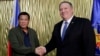 Philippine President Rodrigo Duterte, left, greets U.S. Secretary of State Mike Pompeo at Villamor Air Base in Pasay city southeast of Manila, Philippines, Feb. 28, 2019. Pompeo arrived for talks on the two countries' relations and mutual defense treaty.