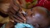 FILE - A child receives an oral Malaria vaccine at Chileka Health Center, in Lilongwe, Malawi in this undated handout photo from UNICEF.