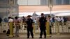 Policemen stand on the road at Tiananmen Square on a hazy day in Beijing on the 24th anniversary of a military crackdown on a pro-democracy movement, June 4, 2013.