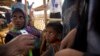 A newly arrived Rohingya Muslim boy looks as a UNHCR volunteer takes the measurement after their arrival at the transit camp at Balukhali refugee camp 50 kilometres (32 miles) from Cox's Bazar, Bangladesh, Sunday, Jan. 14, 2018.