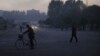 FILE - North Koreans make their way across an intersection at the end of a work day in Pyongyang, North Korea.
