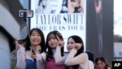 Women pose for a selfie before Taylor Swift's concert at Tokyo Dome in Tokyo, on Feb. 10, 2024.