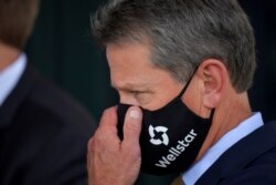 El gobernador de Georgia, Brian Kemp se ajusta la máscara antes de firmar una ley en el hospital Wellstar Kennestone, en Marietta, el 16 de julio de 2020.