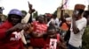 Supporters of Ugandan musician turned politician, Robert Kyagulanyi also known as Bobi Wine, chant slogans outside his home after he arrived from the U.S. in Kampala, Uganda, Sept. 20, 2018. 