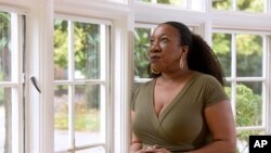 Tarana Burke, founder and leader of the #MeToo movement, stands in her home in Baltimore Oct. 13, 2020, as the movement marks the third year since it received global recognition.