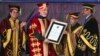 Afghan President Hamid Karzai receives an honorary degree from his Indian counterpart Pranab Mukherjee, second right, at the Lovely Professional University in Jalandhar, India, May 20, 2013.