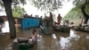 A man drags a trunk to higher ground after floodwaters inundated homes along the banks of the Yamuna River, in New Delhi, India, June 19, 2013.