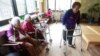 FILE - Kim Gun-ja, 89, right, former comfort woman who was forced to serve for the Japanese troops as a sexual slave during World War II, passes by other comfort woman Yi Ok-seon, 88, left, and Kim Wei-han, 86, at the House of Sharing, a nursing home.