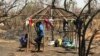 FILE - Two South Sudanese brothers build a hut at the Imvempi settlement in Arua district, Uganda, Jan. 30, 2018. (H. Athumani/VOA)